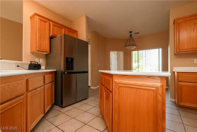 3567 Cottage Stream Ct, Laughlin, NV 89029 - kitchen featuring stainless steel refrigerator with ice dispenser, light tile patterned floors, a center island, and light countertops