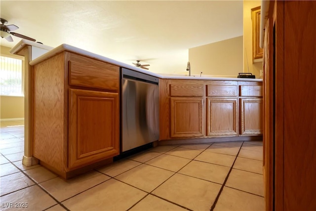 3567 Cottage Stream Ct, Laughlin, NV 89029 - kitchen with dishwasher, ceiling fan, brown cabinets, a sink, and light tile patterned flooring