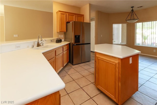 3567 Cottage Stream Ct, Laughlin, NV 89029 - kitchen with stainless steel fridge with ice dispenser, a sink, light tile patterned floors, and light countertops