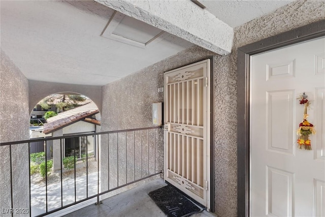 doorway to property featuring stucco siding