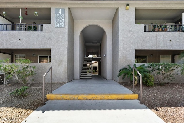 view of exterior entry featuring stucco siding
