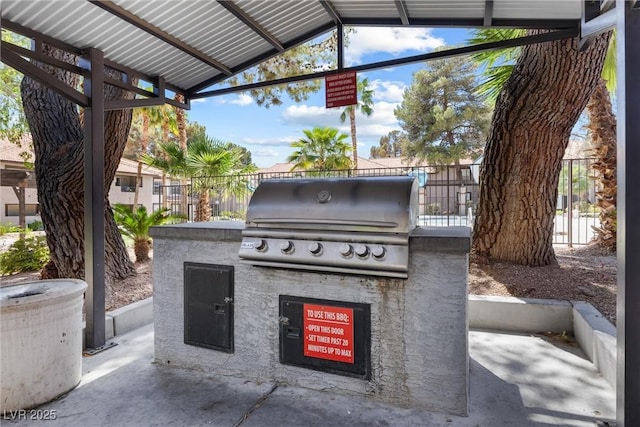 view of patio with area for grilling and a grill