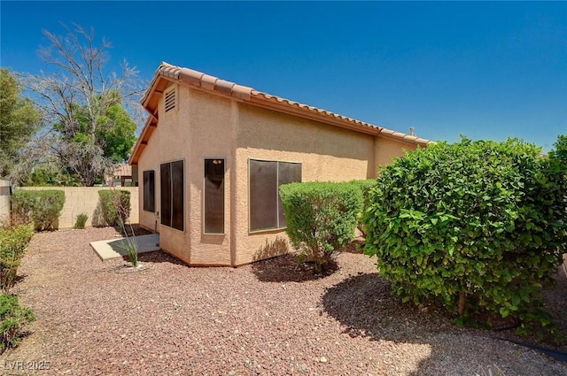 8028 Hurricane Cove Ct, Las Vegas, NV 89129 - view of side of home with stucco siding and fence