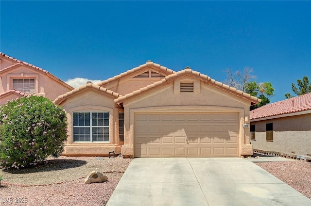 8028 Hurricane Cove Ct, Las Vegas, NV 89129 - view of front of house featuring stucco siding, a tile roof, an attached garage, and concrete driveway