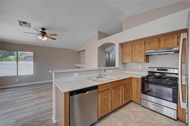 8028 Hurricane Cove Ct, Las Vegas, NV 89129 - kitchen with vaulted ceiling, a sink, stainless steel appliances, under cabinet range hood, and visible vents