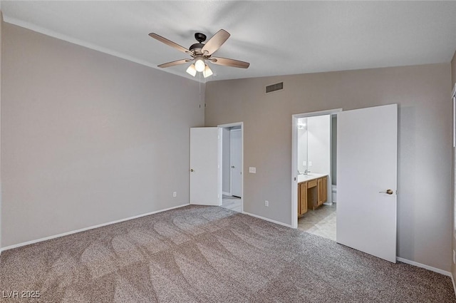 8028 Hurricane Cove Ct, Las Vegas, NV 89129 - unfurnished bedroom with light carpet, baseboards, visible vents, lofted ceiling, and connected bathroom