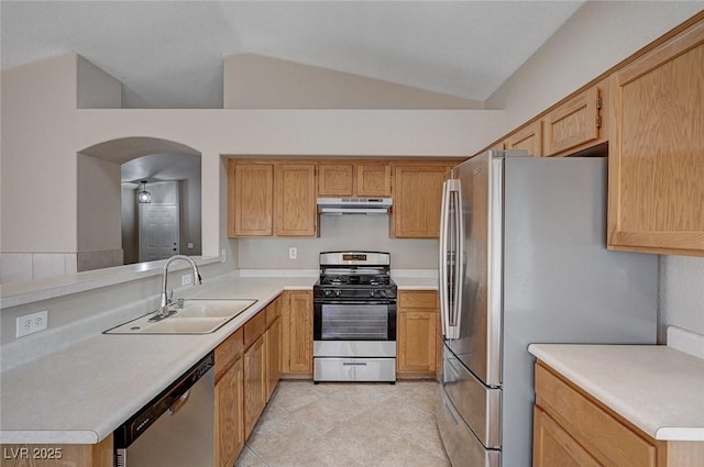 8028 Hurricane Cove Ct, Las Vegas, NV 89129 - kitchen with a sink, arched walkways, vaulted ceiling, under cabinet range hood, and appliances with stainless steel finishes