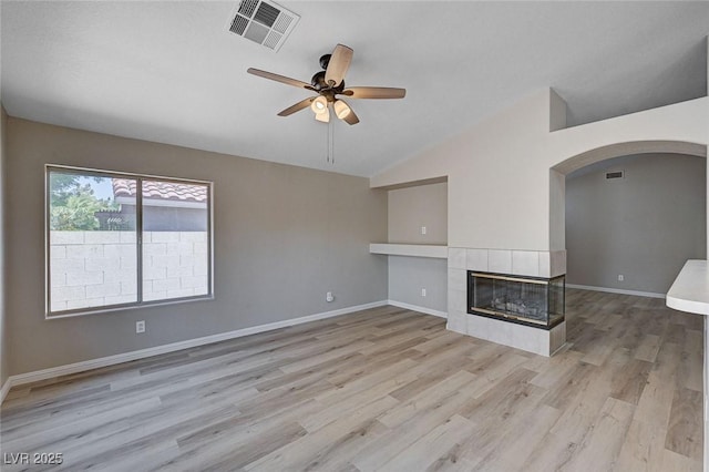 8028 Hurricane Cove Ct, Las Vegas, NV 89129 - unfurnished living room with arched walkways, vaulted ceiling, visible vents, light wood-style floors, and ceiling fan