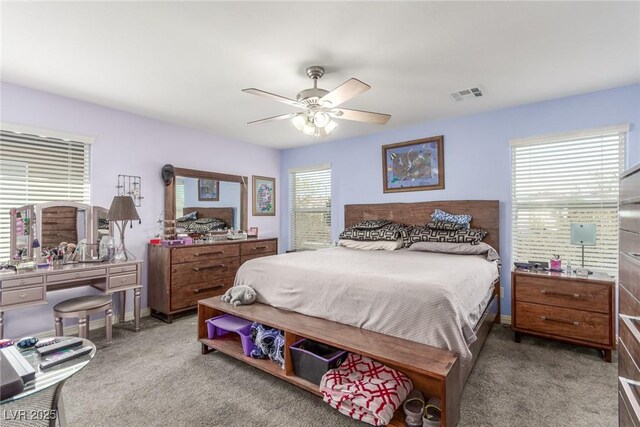 bedroom with baseboards, visible vents, carpet floors, and ceiling fan