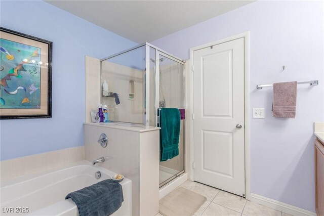 bathroom with a garden tub, a stall shower, vanity, baseboards, and tile patterned flooring