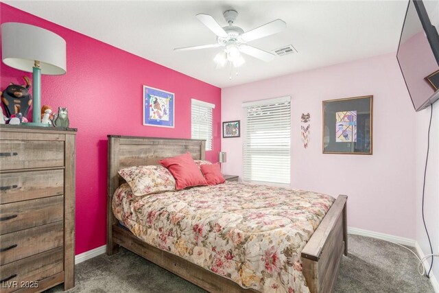 carpeted bedroom with ceiling fan, baseboards, and visible vents