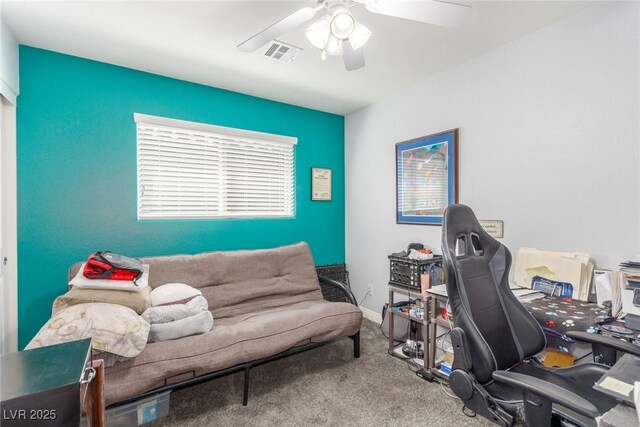 office area featuring a ceiling fan, visible vents, and carpet