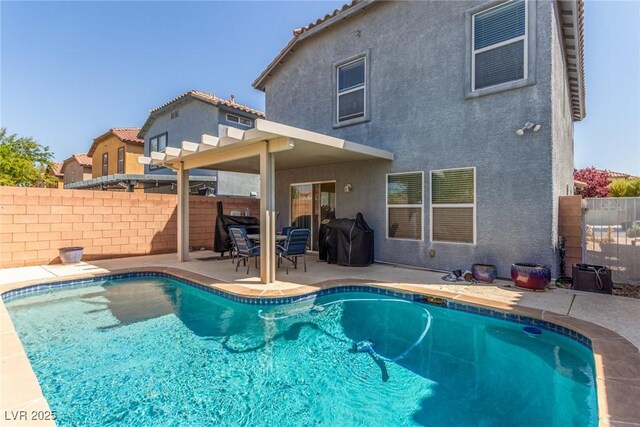 view of pool with area for grilling, a patio area, a fenced in pool, and a fenced backyard