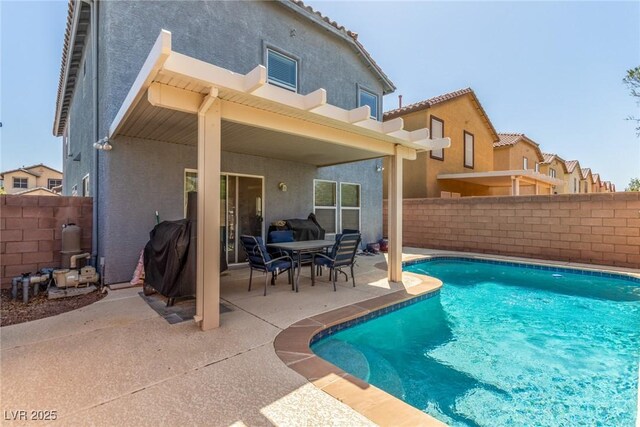 back of property with a fenced in pool, a patio, a fenced backyard, and stucco siding