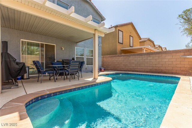 view of swimming pool featuring fence, a patio, and a fenced in pool