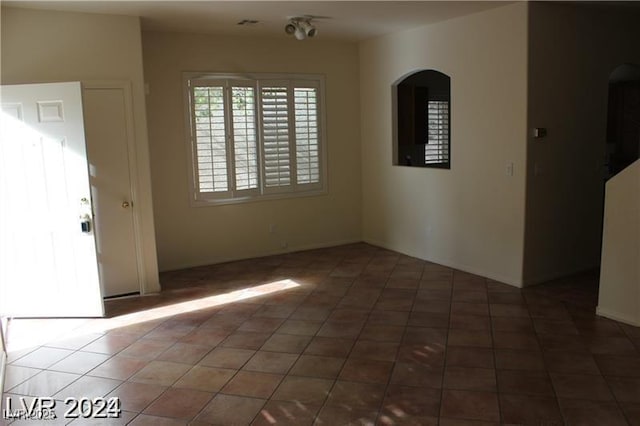 interior space with arched walkways and baseboards