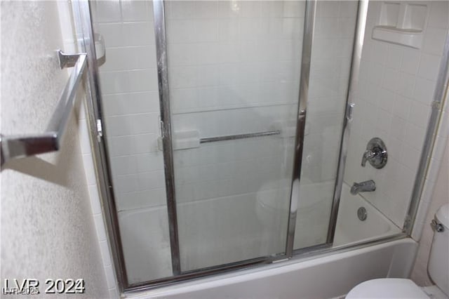full bathroom featuring shower / bath combination with glass door and toilet