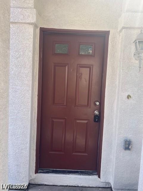 property entrance featuring stucco siding
