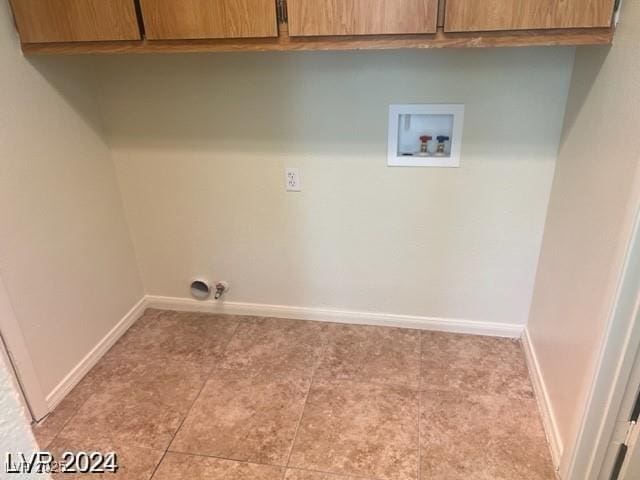 washroom featuring baseboards, cabinet space, and hookup for a washing machine