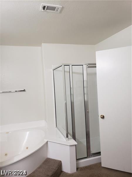 bathroom with a shower stall, a whirlpool tub, and visible vents