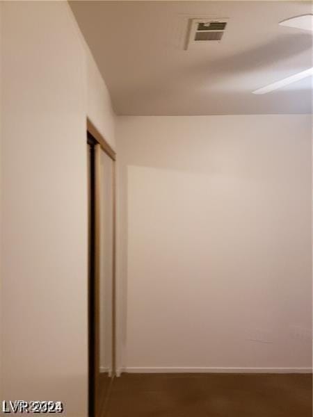 corridor featuring visible vents and baseboards