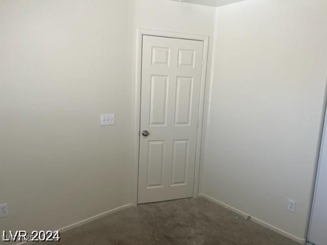 empty room with carpet and baseboards