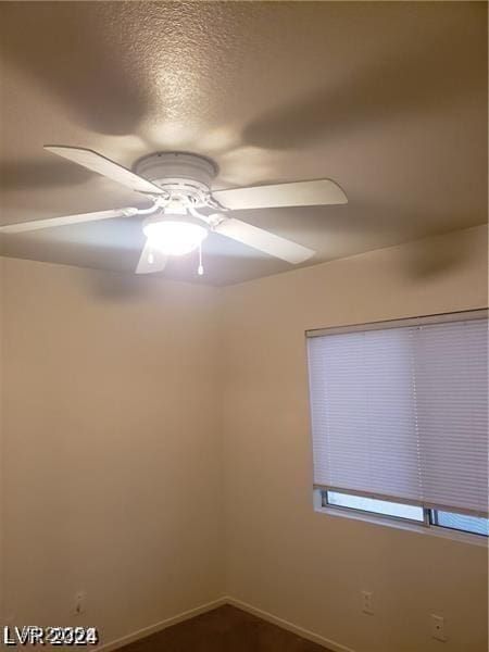 spare room featuring baseboards and ceiling fan