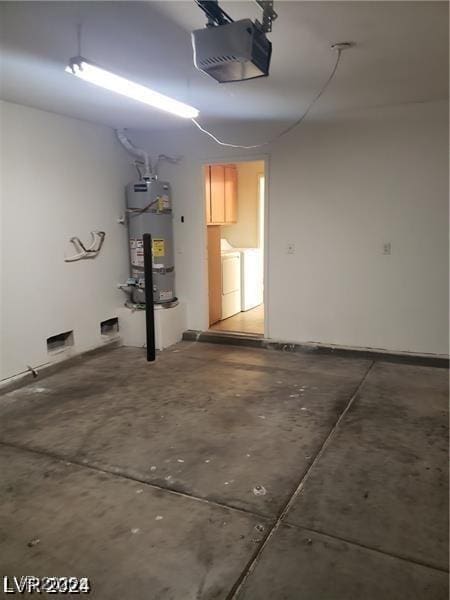 garage with separate washer and dryer, strapped water heater, and a garage door opener