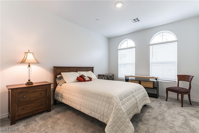 bedroom featuring light carpet, baseboards, and visible vents