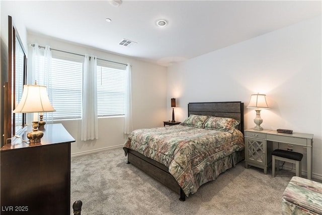 carpeted bedroom featuring visible vents and baseboards