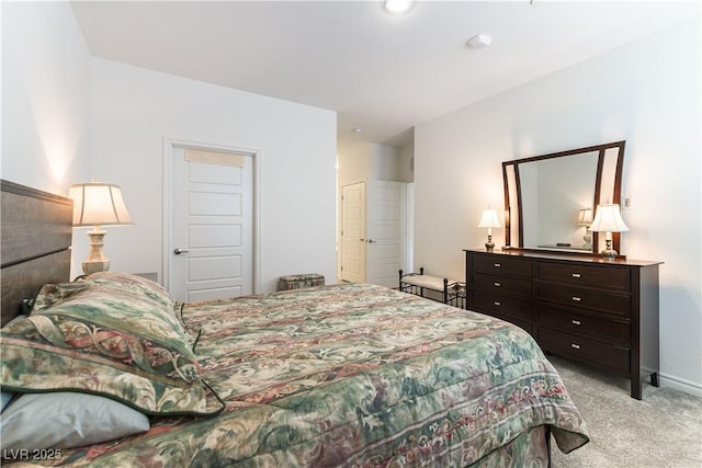 bedroom featuring light carpet