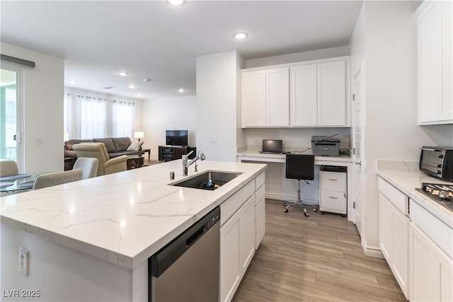 kitchen featuring white cabinets, stainless steel appliances, a sink, and recessed lighting