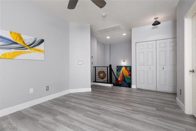 unfurnished living room with wood finished floors, ceiling fan, baseboards, visible vents, and recessed lighting