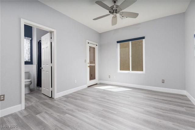 689 Principle Point Ave, Henderson, NV 89012 - unfurnished bedroom featuring light wood-style flooring, baseboards, connected bathroom, and a ceiling fan