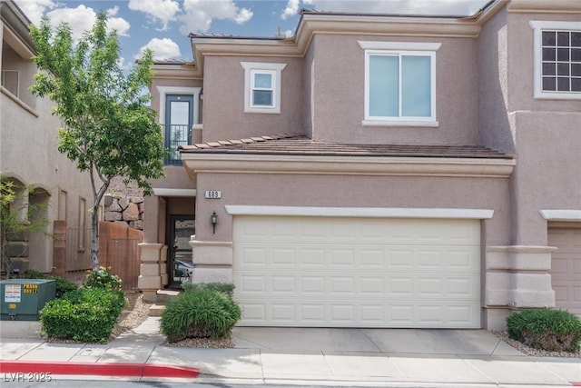 view of front of house featuring stucco siding, an attached garage, and concrete driveway
