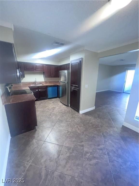 3151 Soaring Gulls Dr Unit 1092, Las Vegas, NV 89128 - kitchen featuring a sink, open floor plan, baseboards, freestanding refrigerator, and dishwashing machine