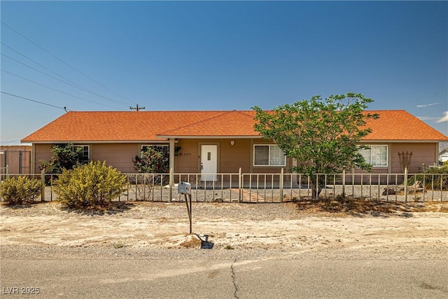 ranch-style home with a fenced front yard