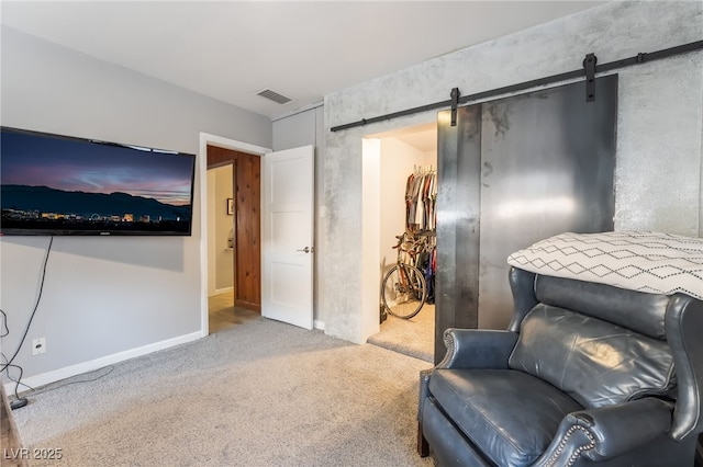 650 Arizona St, Boulder City, NV 89005 - living area with baseboards, visible vents, carpet floors, and a barn door
