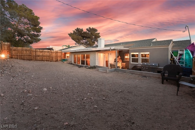 650 Arizona St, Boulder City, NV 89005 - back of property with a chimney, fence, and roof with shingles