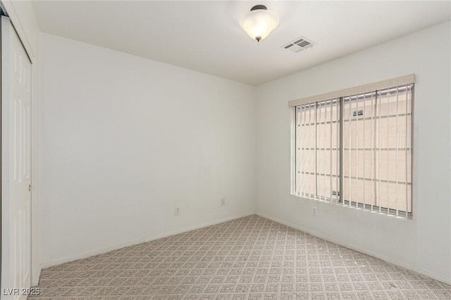 unfurnished room with light colored carpet, baseboards, and visible vents