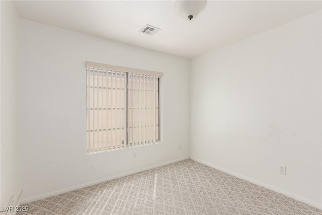carpeted empty room with baseboards and visible vents