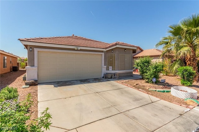 single story home featuring an attached garage, driveway, cooling unit, and stucco siding