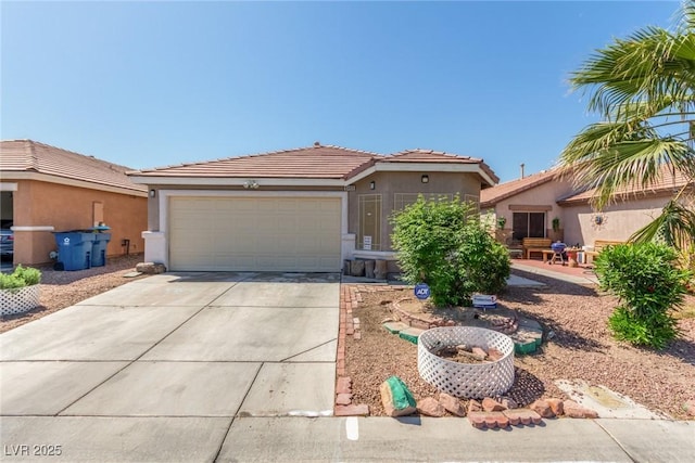 view of front of home featuring stucco siding, driveway, a tiled roof, and a garage
