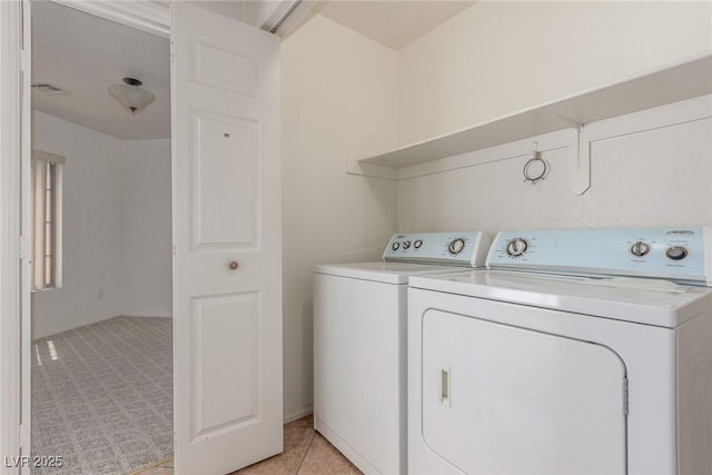 washroom featuring visible vents, washer and dryer, and laundry area