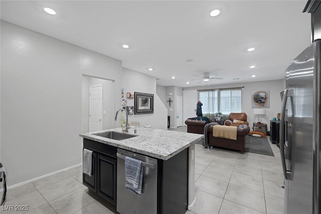 6247 Milford Sound St, Las Vegas, NV 89148 - kitchen featuring stainless steel appliances, a sink, a kitchen island with sink, light tile patterned floors, and ceiling fan