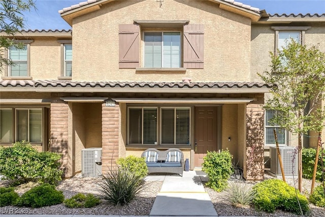 6247 Milford Sound St, Las Vegas, NV 89148 - view of front of house with a tile roof, a porch, central air condition unit, and stucco siding
