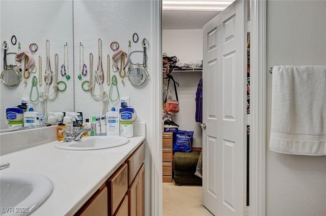8783 Halcon Ave, Las Vegas, NV 89148 - bathroom featuring a walk in closet, a sink, and double vanity