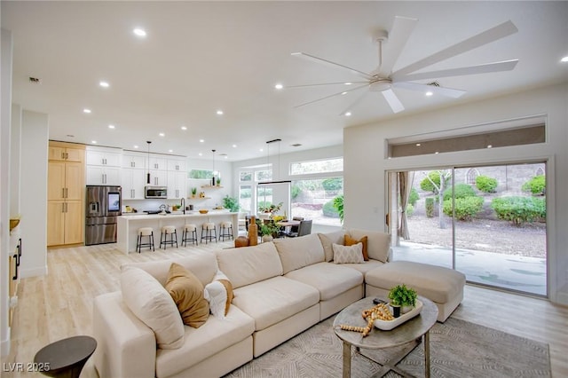10709 Hunters Woods Pl, Las Vegas, NV 89134 - living area featuring recessed lighting, ceiling fan, and light wood-style flooring