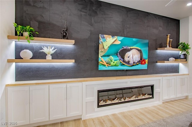 10709 Hunters Woods Pl, Las Vegas, NV 89134 - detailed view of wood finished floors and a glass covered fireplace