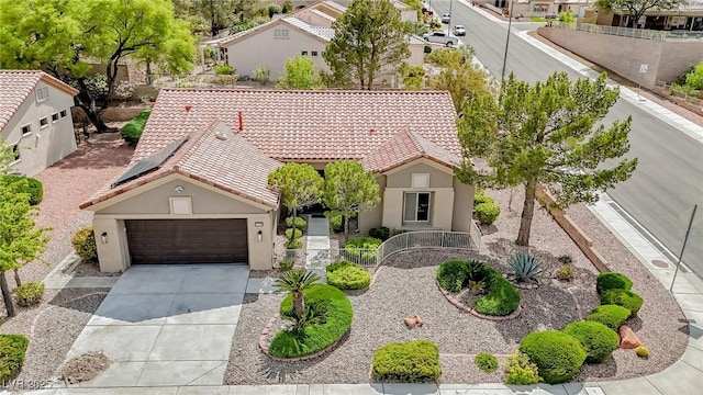 10709 Hunters Woods Pl, Las Vegas, NV 89134 - view of front facade with a tiled roof, stucco siding, driveway, and an attached garage